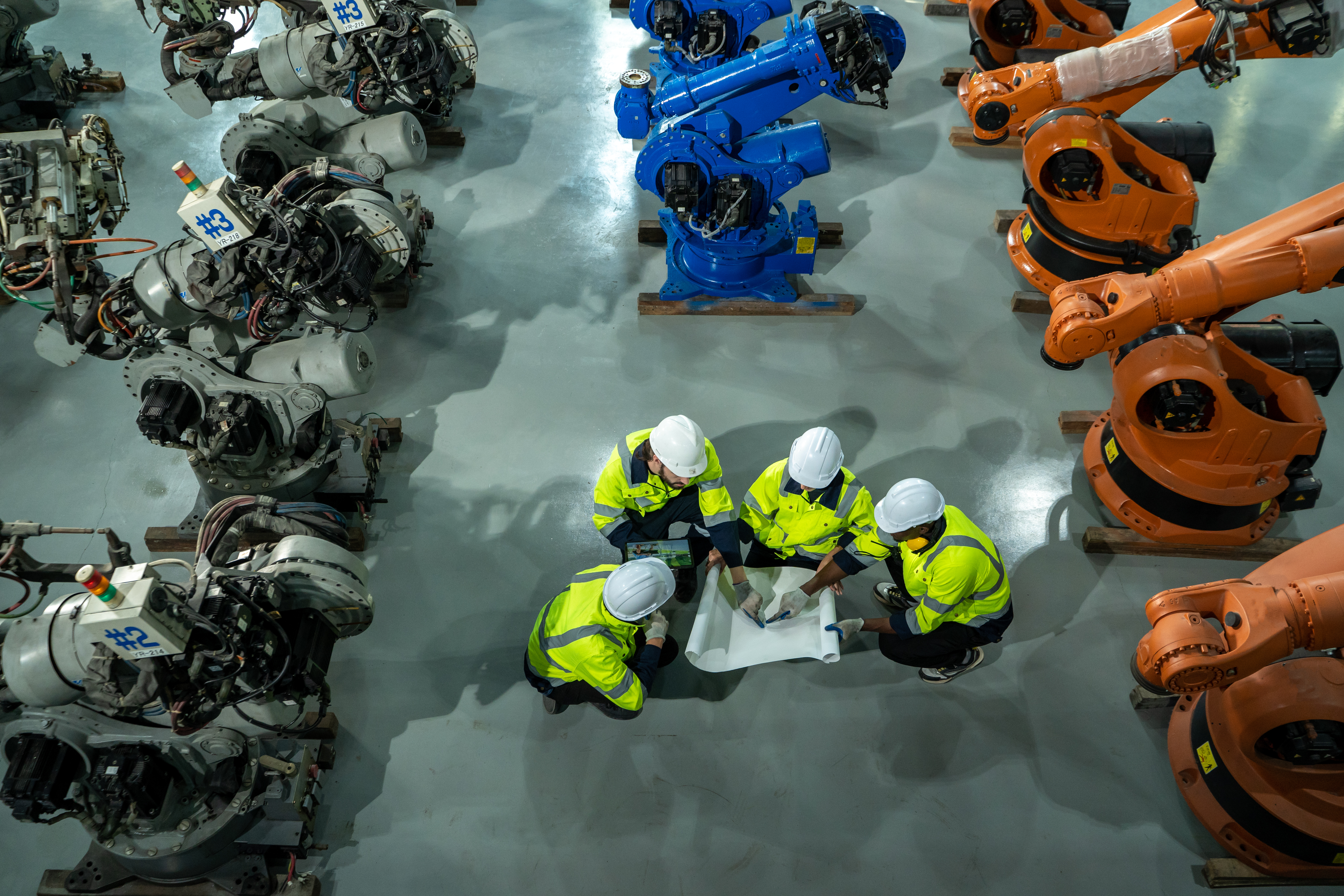 Engineer working alongside an industrial robot, vision data treated as an operational input